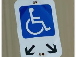 A financial manager in a securities firm who uses a wheelchair was accommodated with an accessible parking space and minor modifications to his workspace.