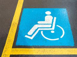 An employee with spina bifida had difficulty accessing the employer's parking lot.