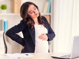 pregnant businesswoman with back pain
