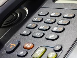 An employee diagnosed with cervical dystonia has reported difficulties holding the phone and using the keyboard at the same time.